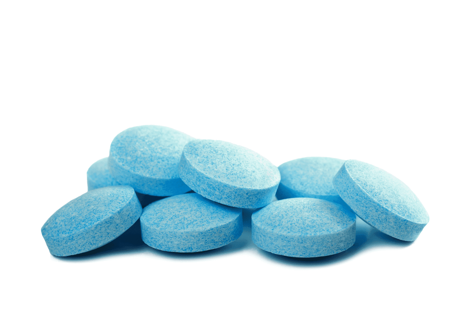 A small pile of round blue tablets on a white background