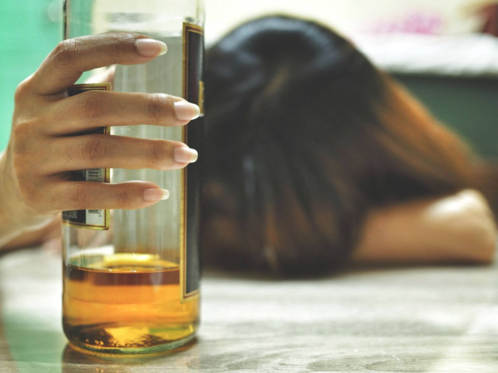 Woman Holding Drink On Table