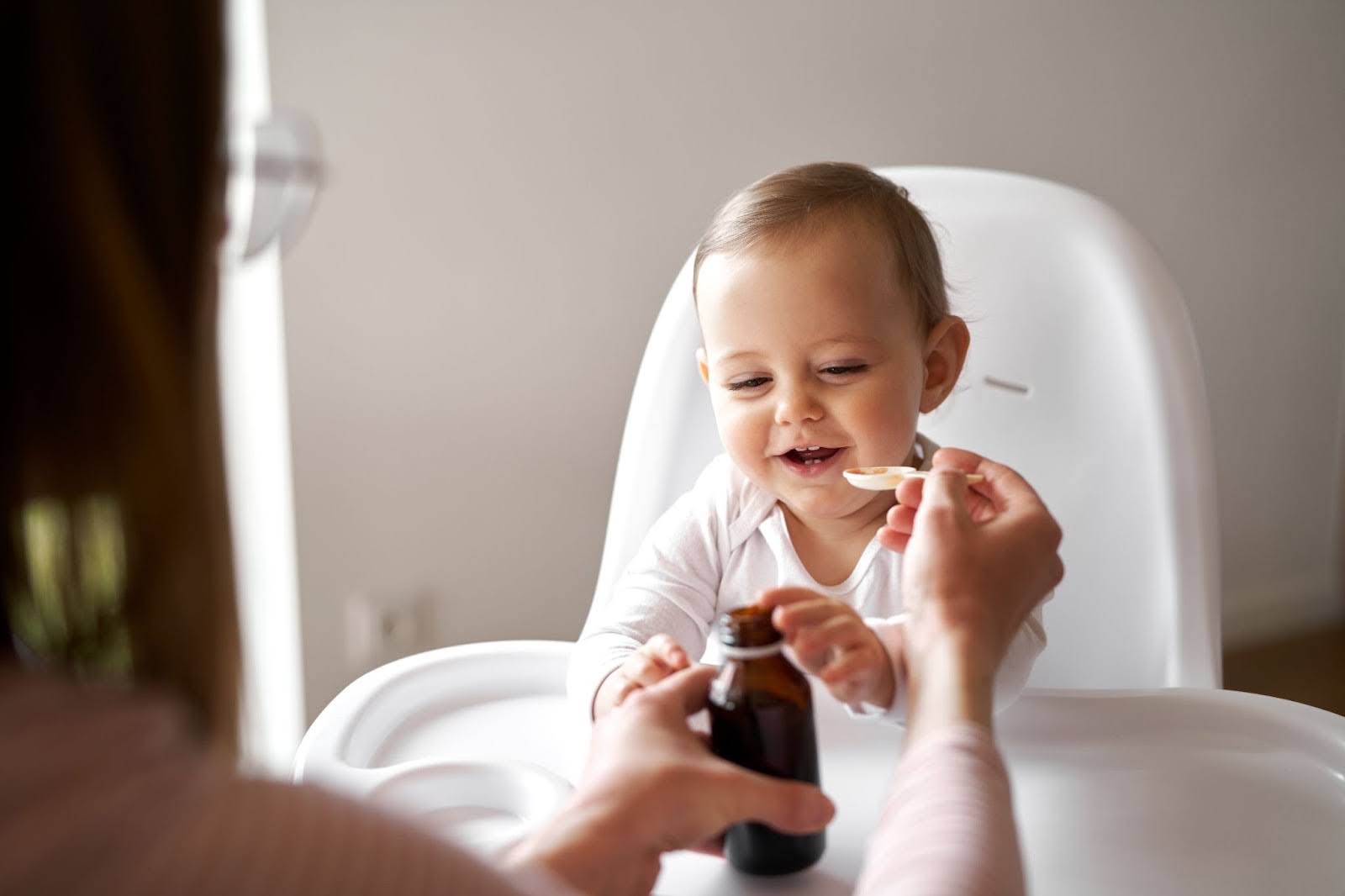 Mother Feeding Medicine to Baby