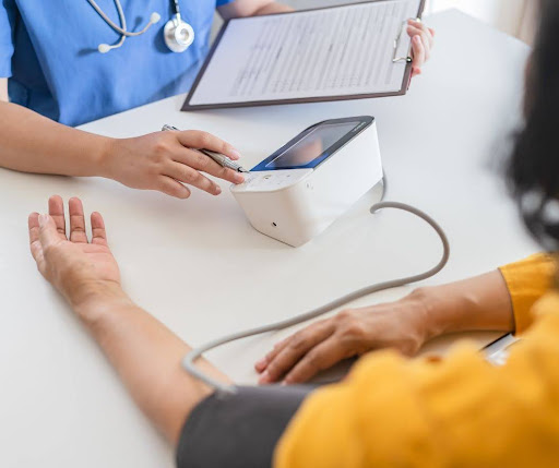Woman getting blood pressure and vital signs taken