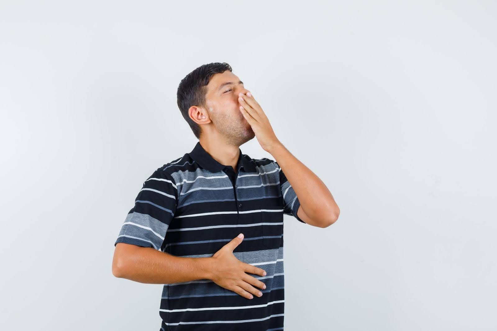 Man with hand on his stomach