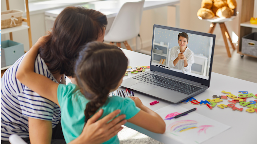 Parent and child talking on telehealth appointment to doctor