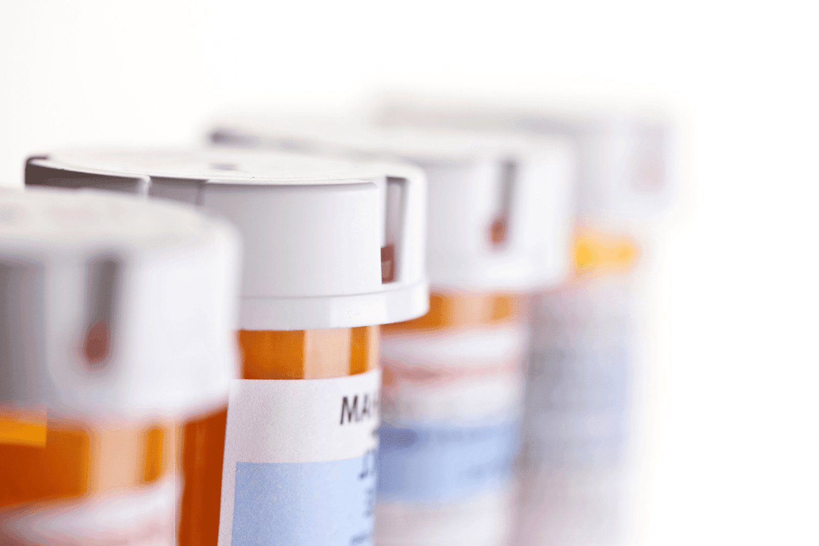 Close-up of several prescription pill bottles in a row