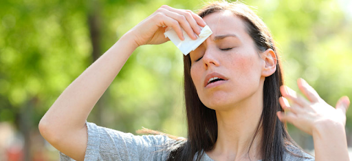 a woman feeling hot and dehydrated