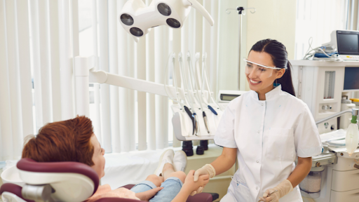 Dentist meeting patient and shaking hands.