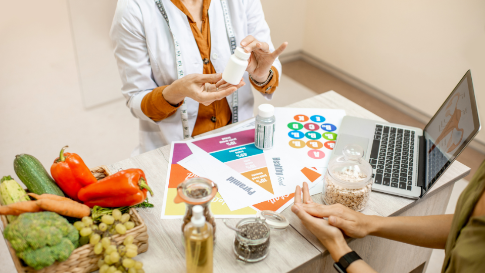 Dietitian with patient showing them healthy foods