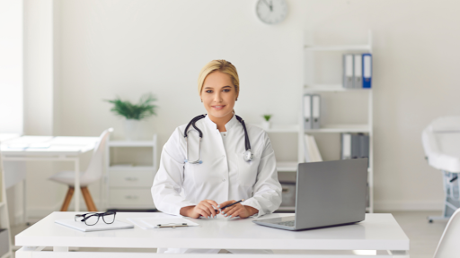 Doctor sitting at desk with laptop