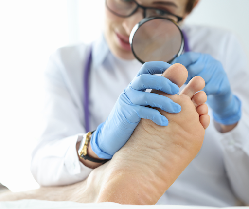 Doctor checking toenail of patient