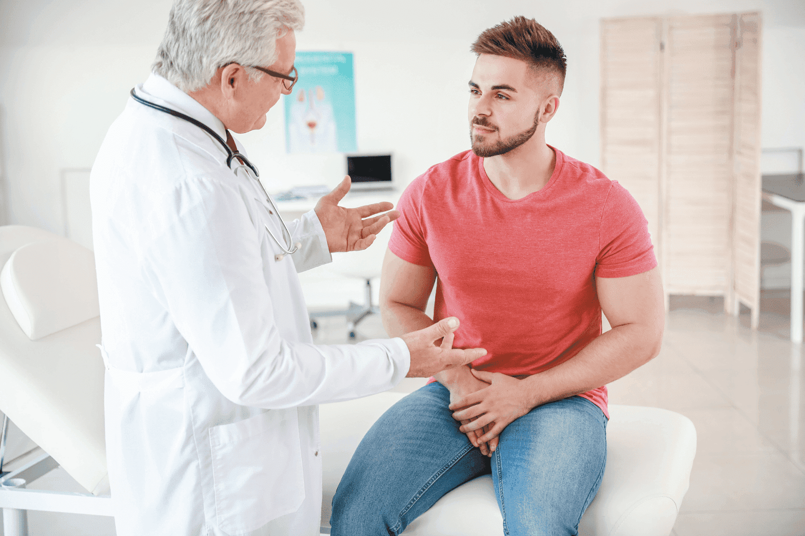 Doctor consulting a young man in a clinic.