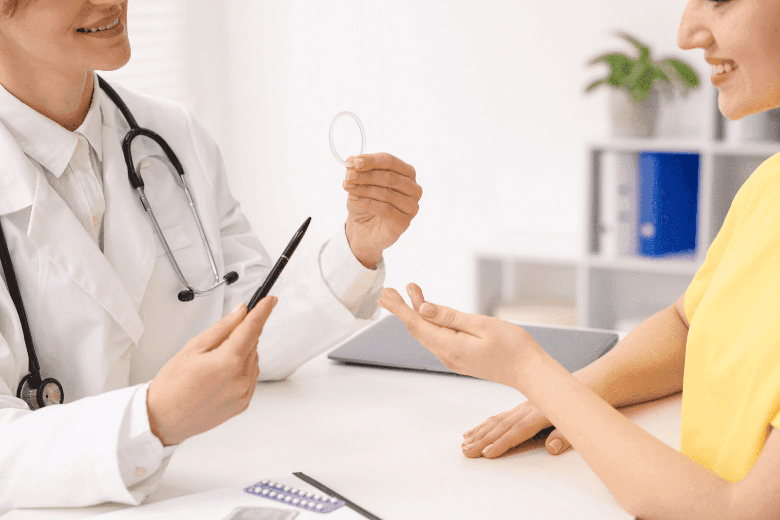 Doctor discussing a contraceptive ring with a patient during a medical consultation.