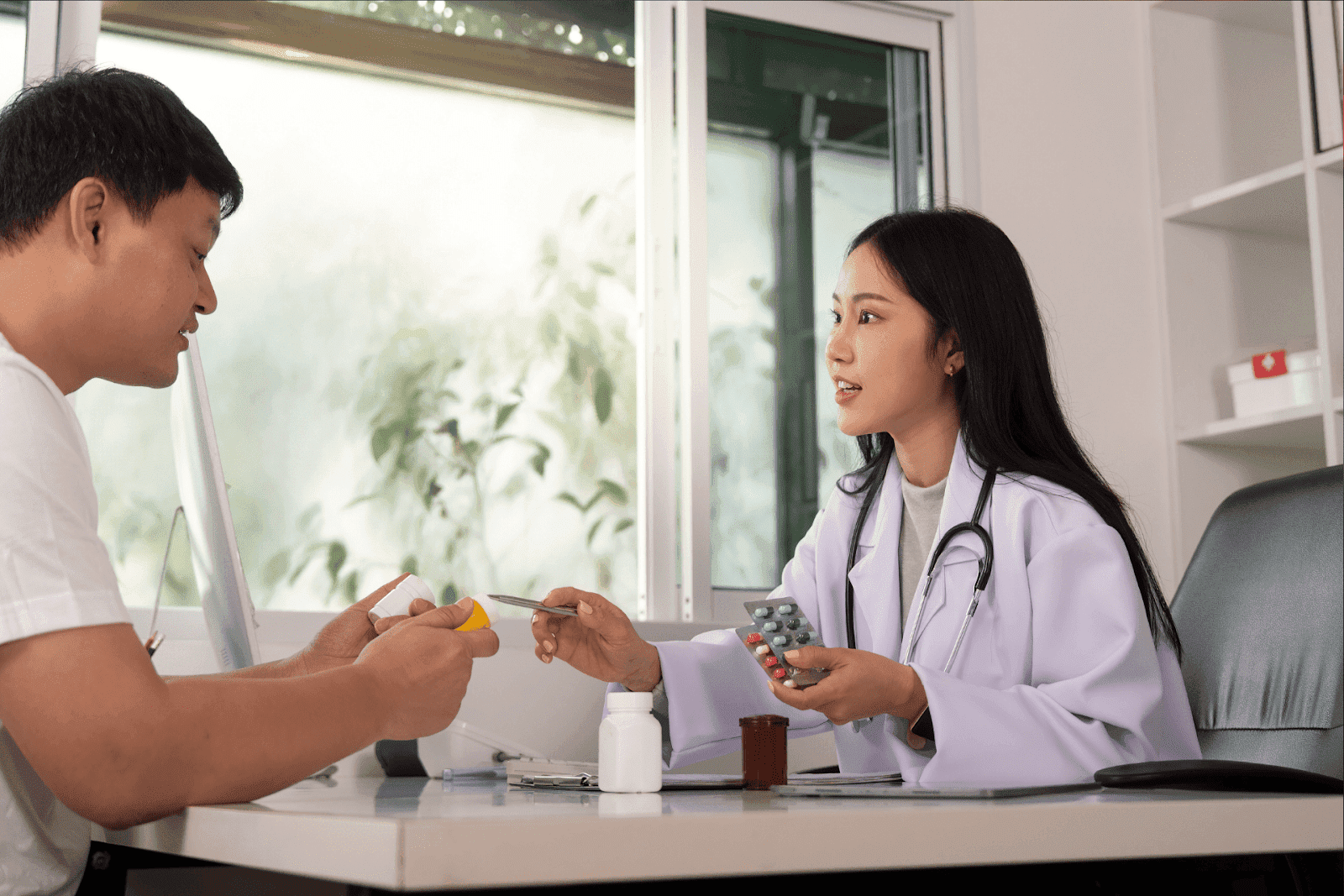 Doctor discussing medication and treatment plan with a patient during a consultation.