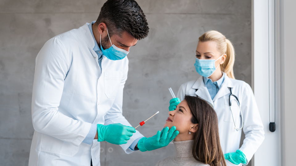 Doctor performing nasal swap test on a patient