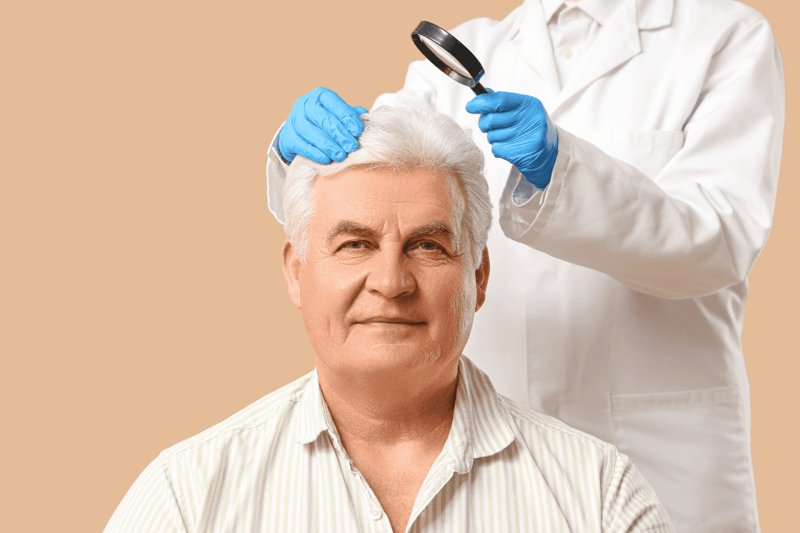 Doctor examining an older man’s scalp with a magnifying glass during a medical checkup.