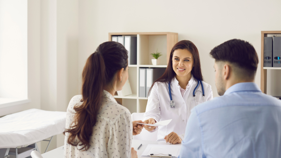 Doctor handing a paper to patient.