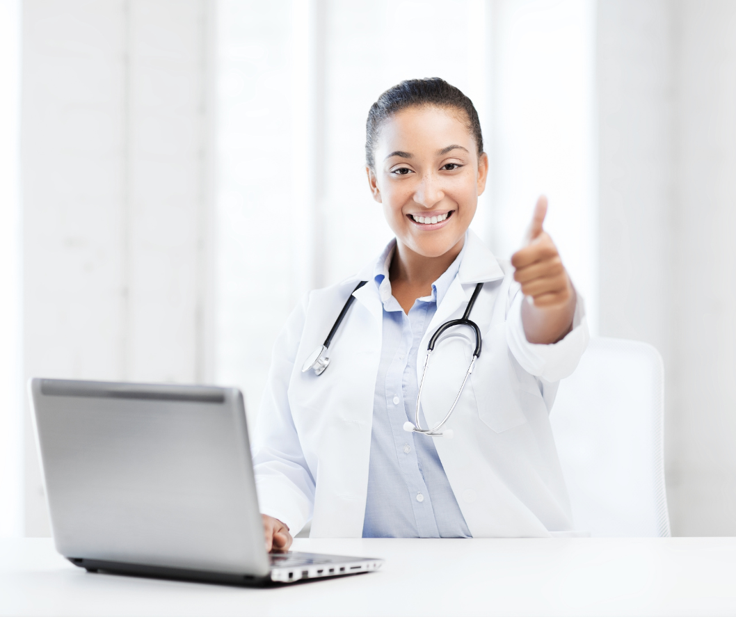 Doctor working on laptop and giving thumbs up