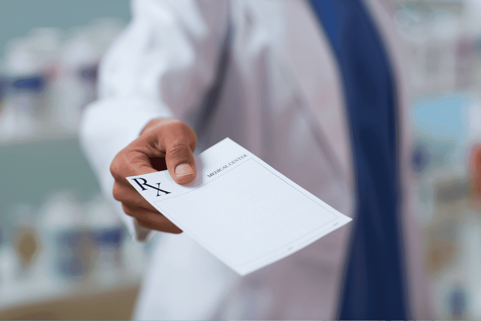 Doctor handing a prescription note to a patient