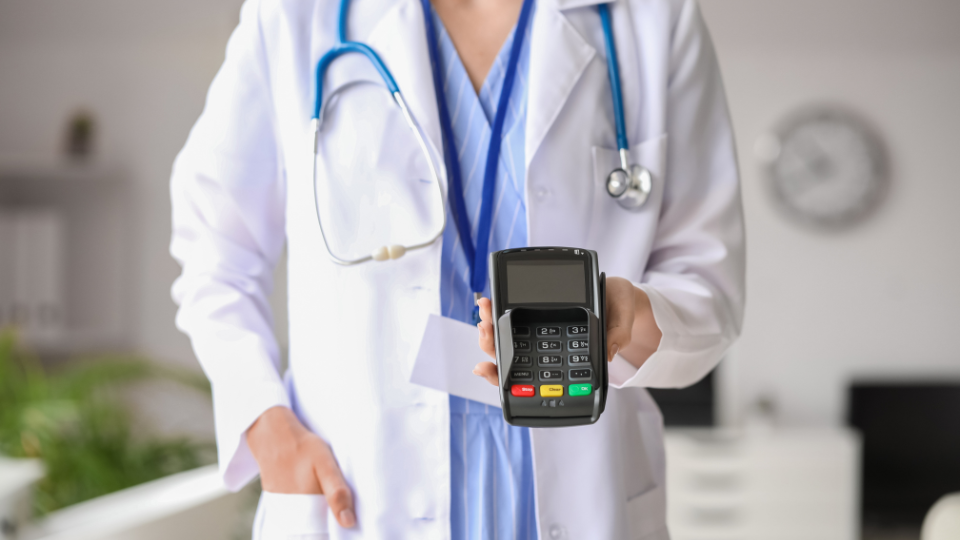 Doctor holding payment processor device