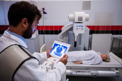 Doctor examining X-ray on digital tablet