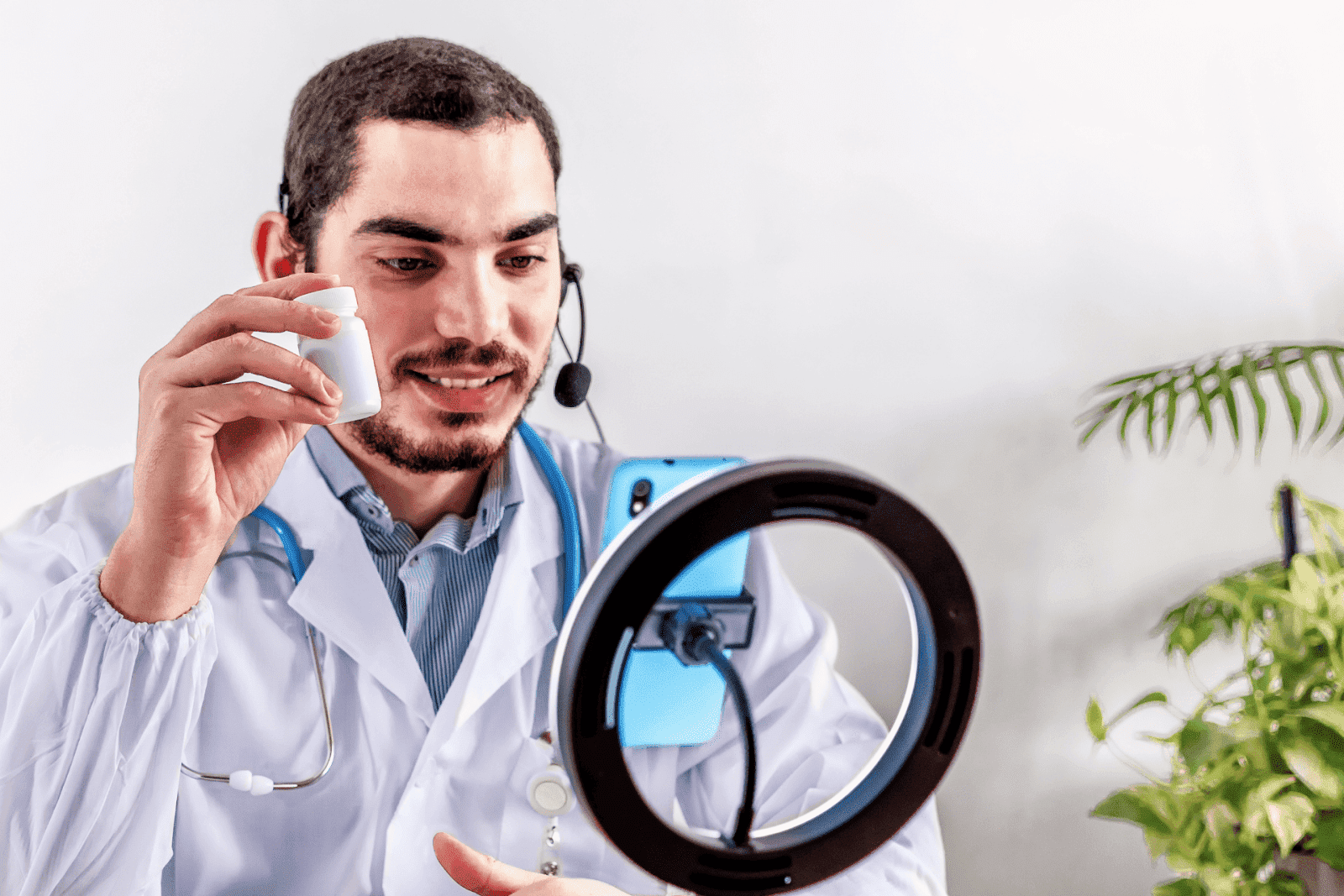 Doctor on video call holding pill bottle