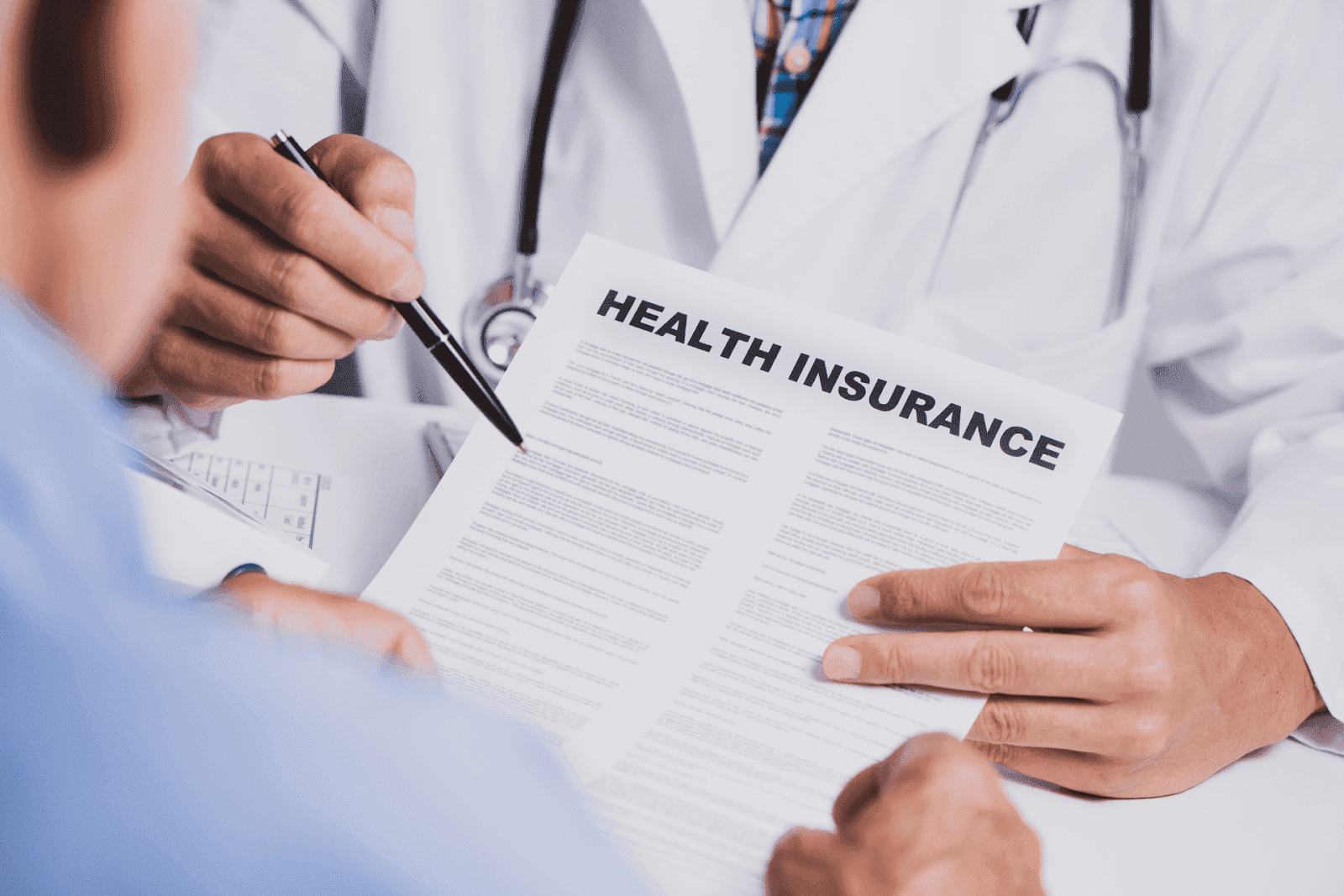 Doctor reviewing a health insurance document with a patient