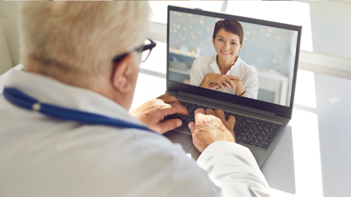 Doctor speaking to a patient via a video call on a laptop