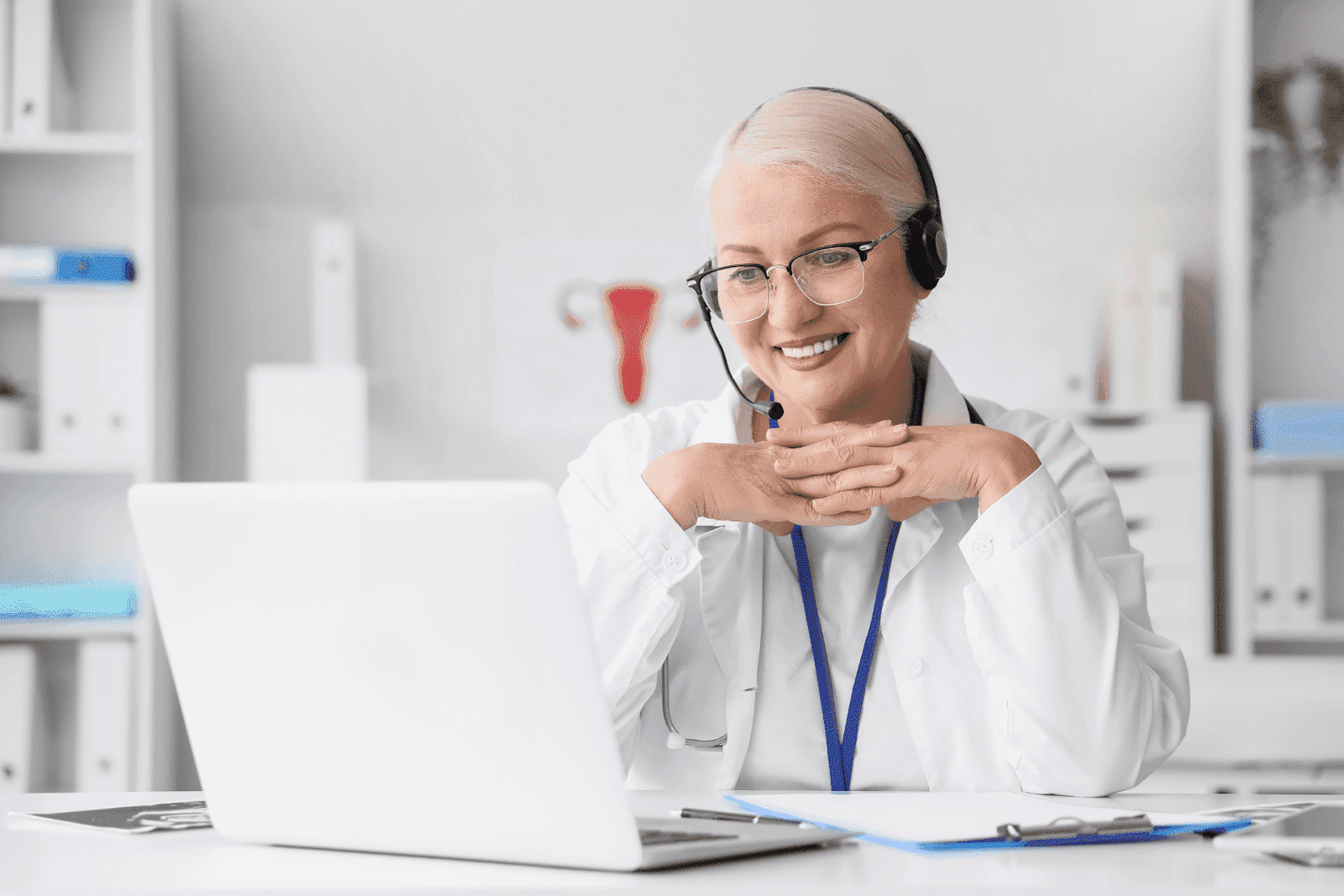 Doctor wearing a headset while conducting an online consultation.Smiling doctor wearing a headset conducting an online consultation at a laptop.