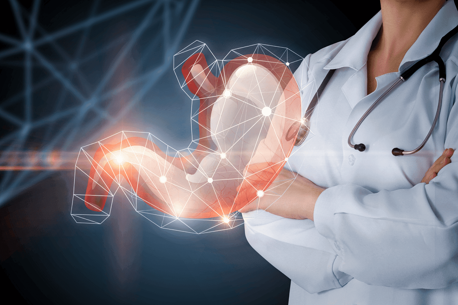 Doctor with stethoscope standing behind a digital illustration of the human stomach.