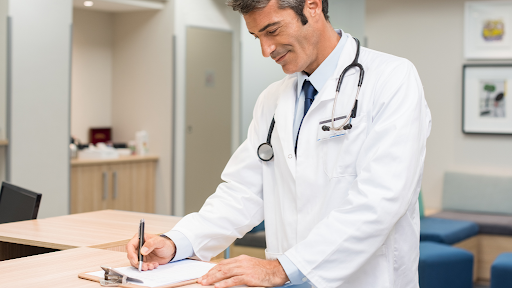 Doctor writing a note on paper