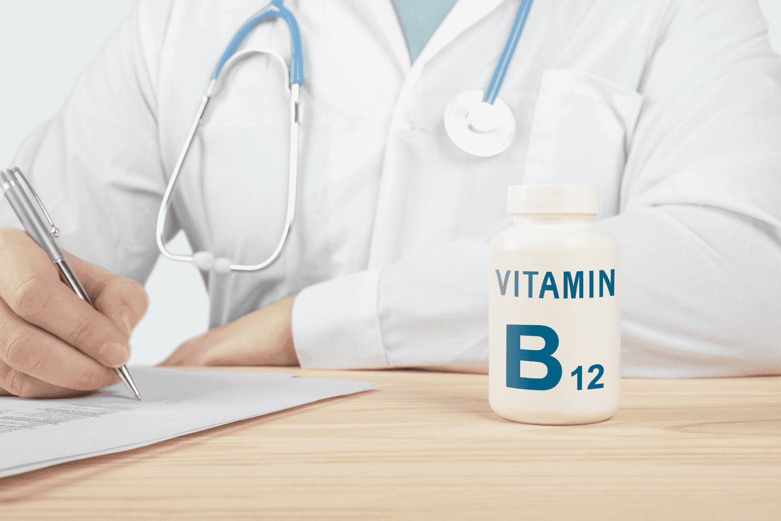 Doctor writing at desk with a bottle labeled Vitamin B12 in the foreground.