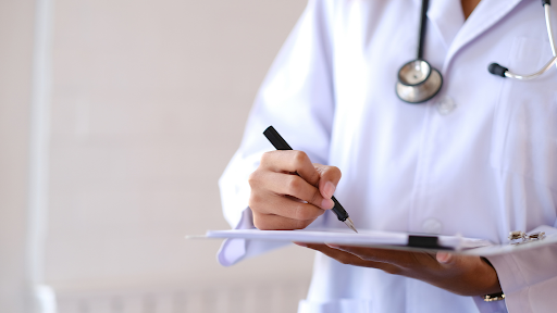 Doctor writing a note on paper