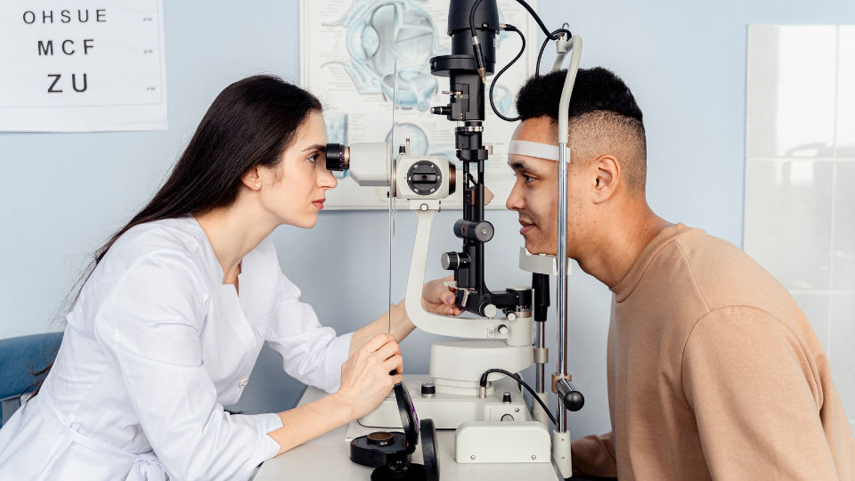 Doctor doing eye exam on male patient