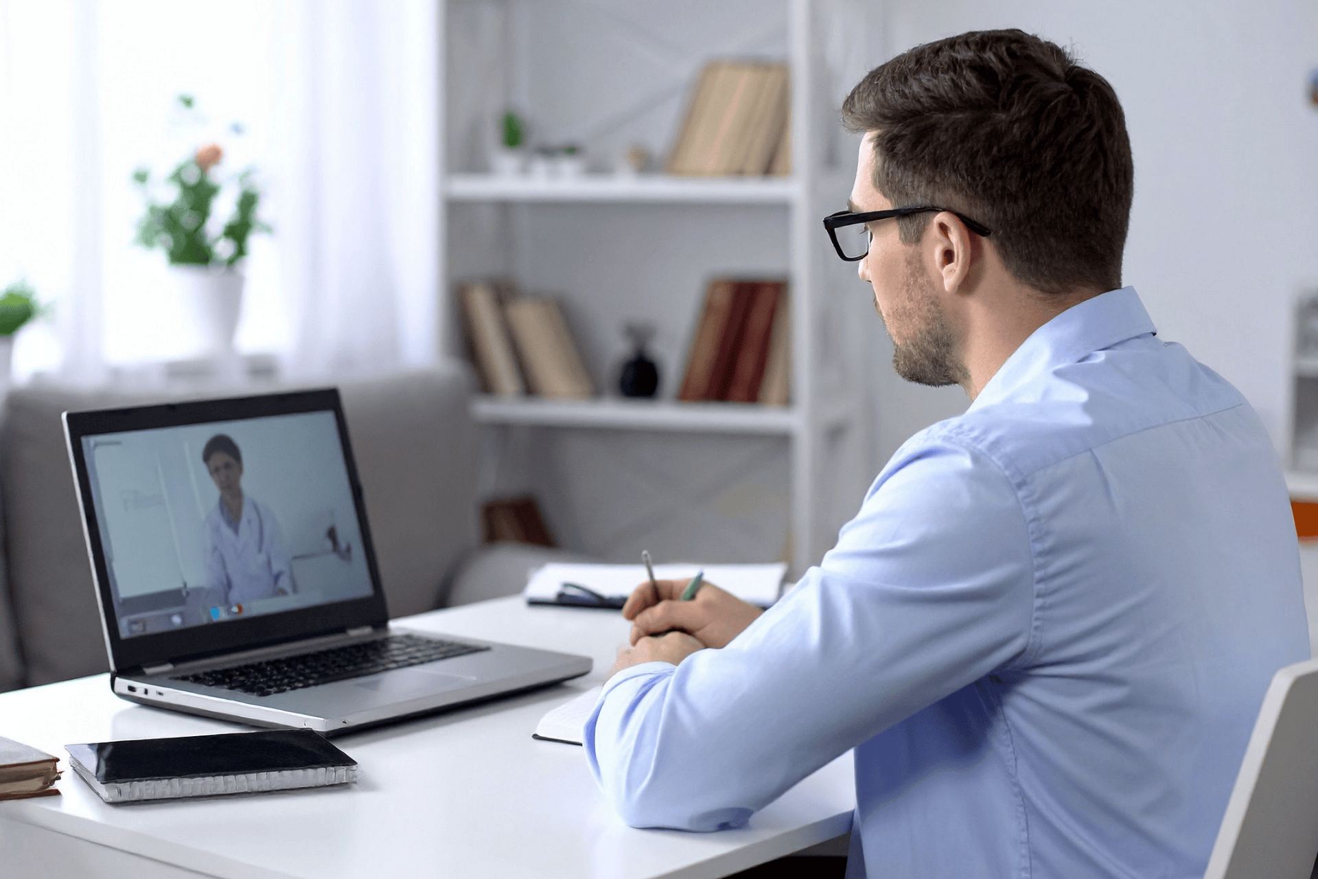 A Man having an online consultation with a doctor on his laptop.A Man having an online consultation with a doctor on his laptop.