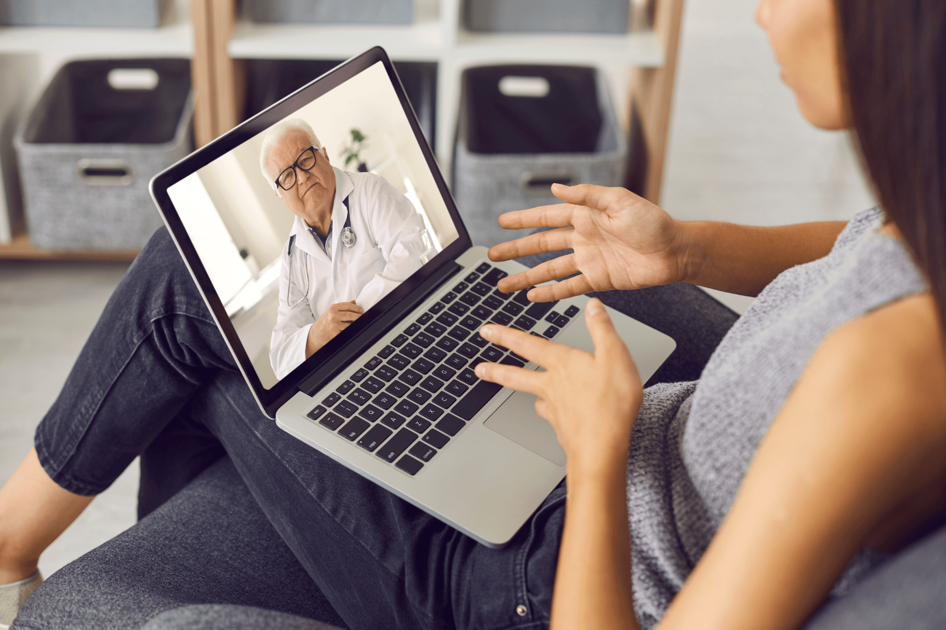 Woman having an online video consultation with a doctor on her laptop.