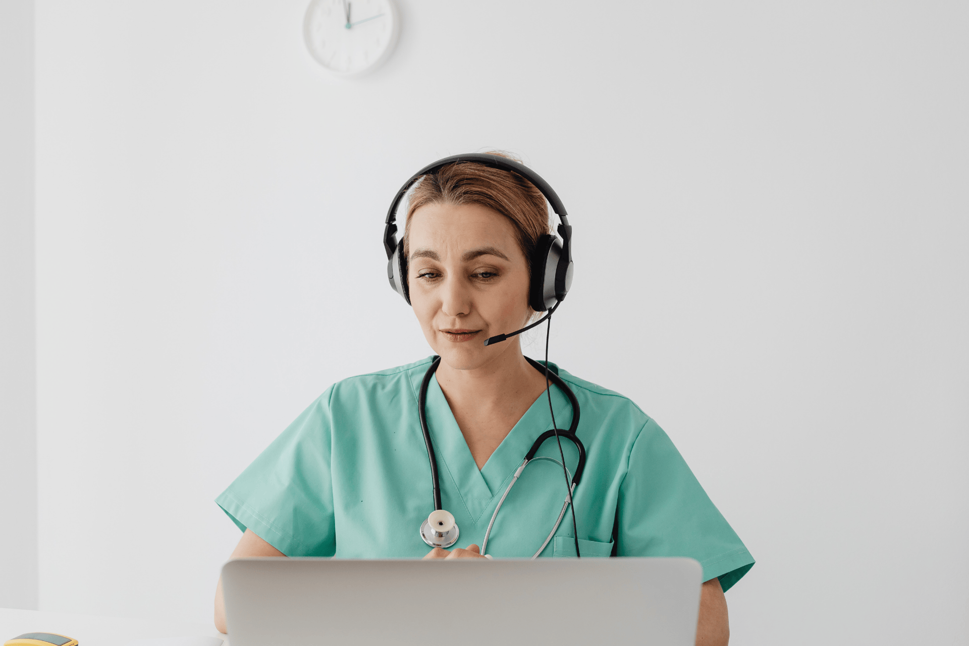 Female healthcare professional wearing a headset during an online consultation.