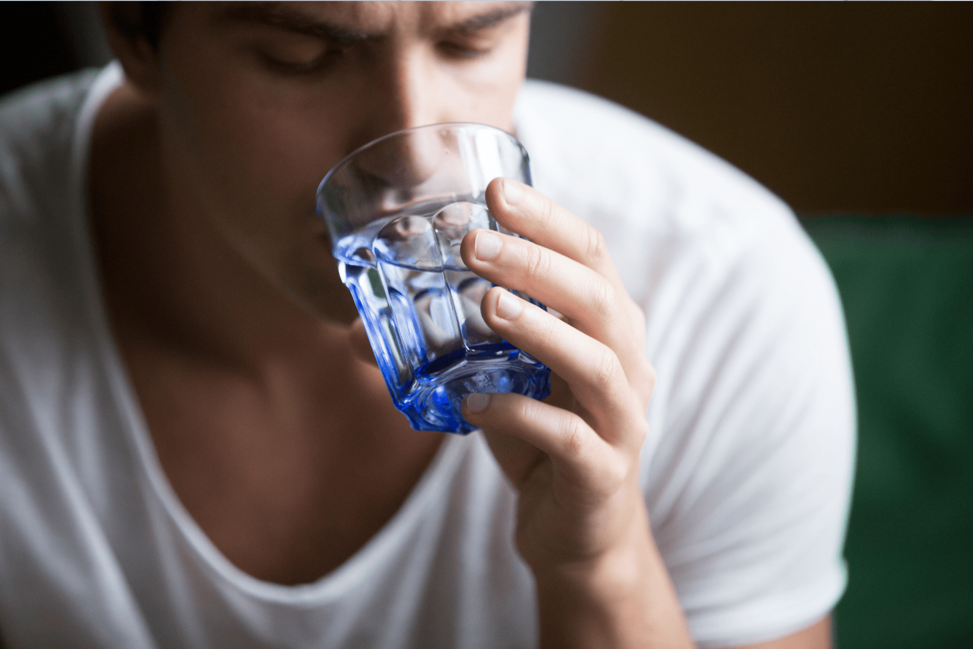 Man drinking a glass of water.