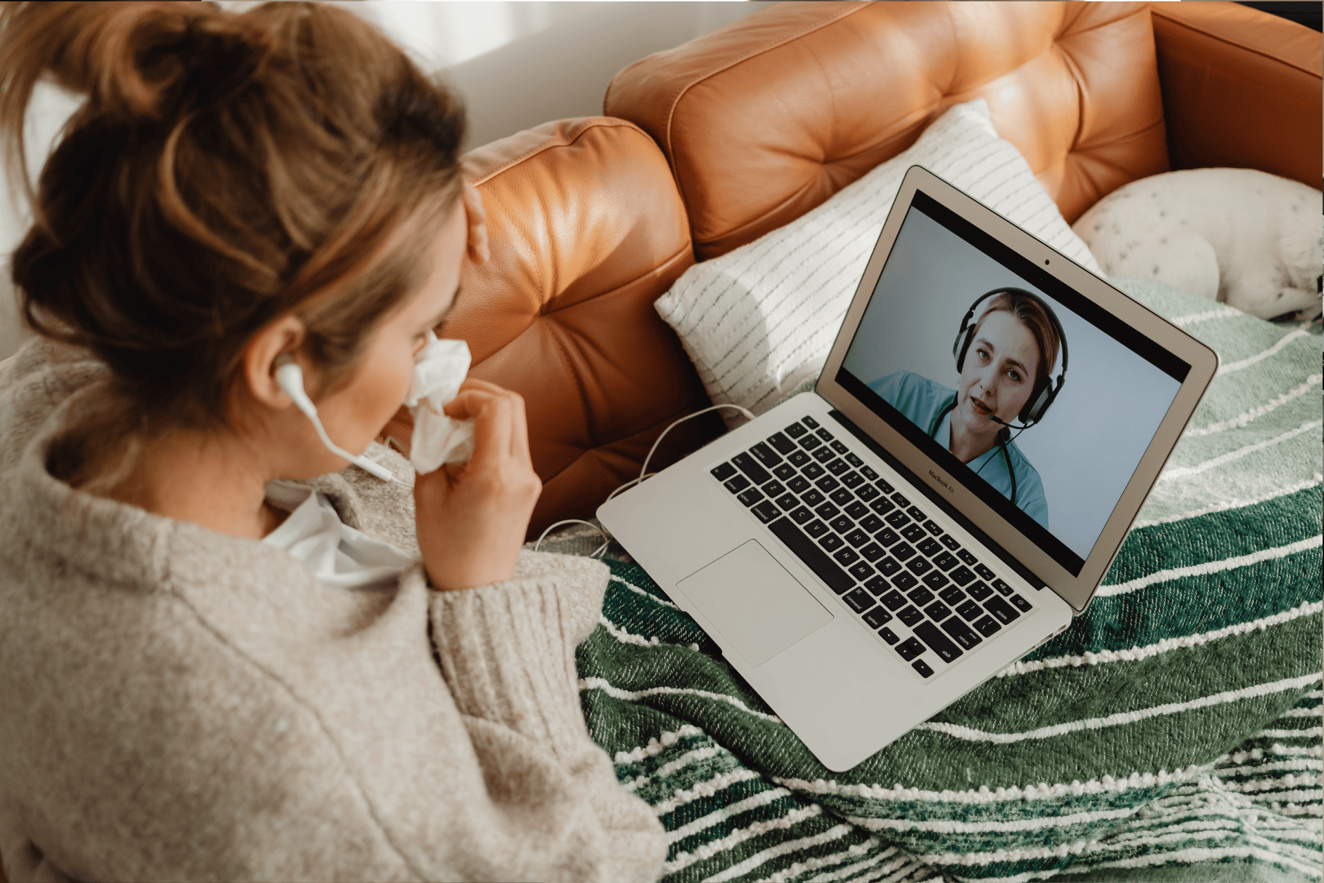 Sick woman having an online consultation with a doctor on her laptop.