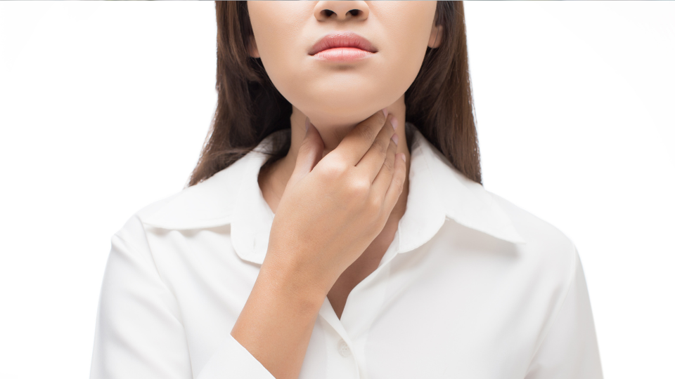 Woman holding her throat with her right hand