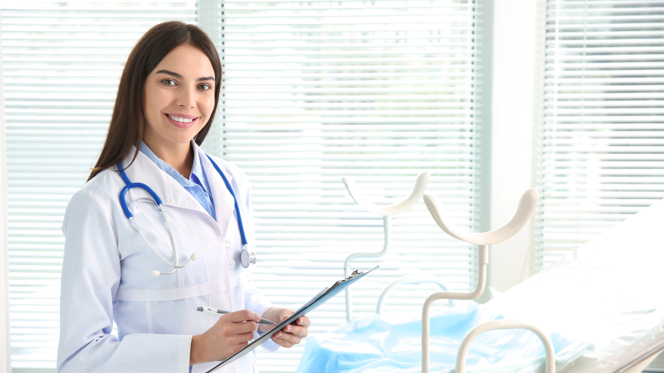 Gynecologist holding clipboard and smiling