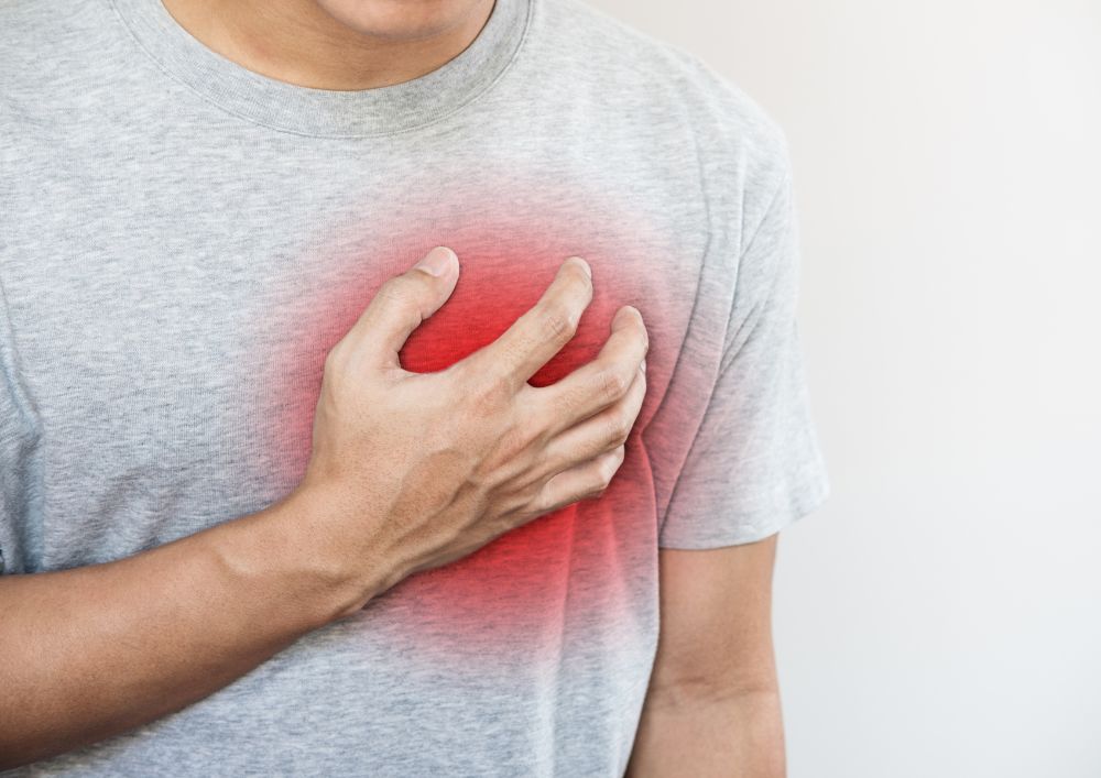 Man holding his chest due to pain
