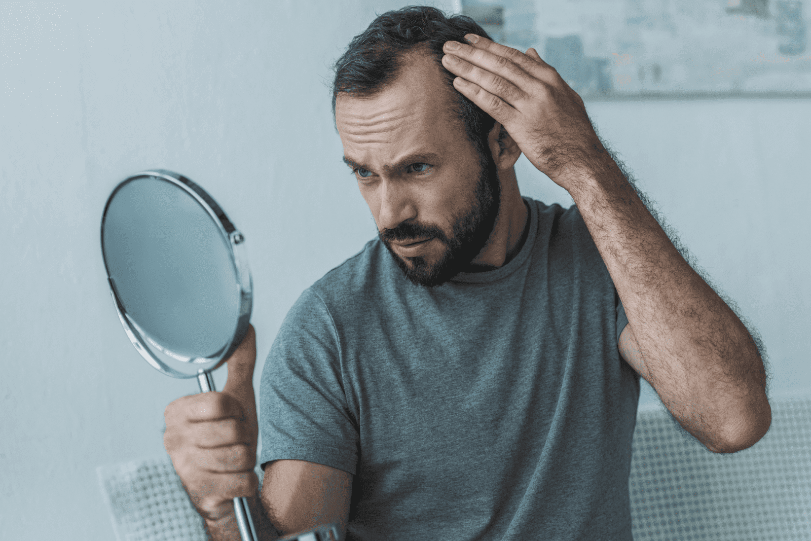 Man checking hair loss in the mirror.