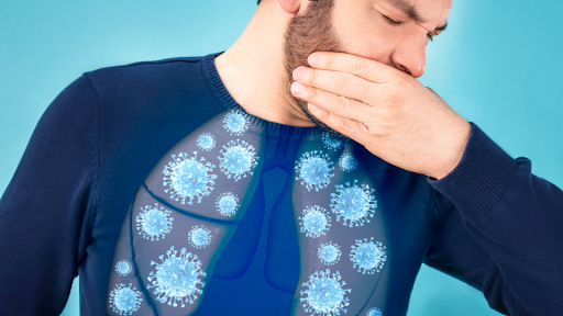 Man coughing and covering mouth with left hand