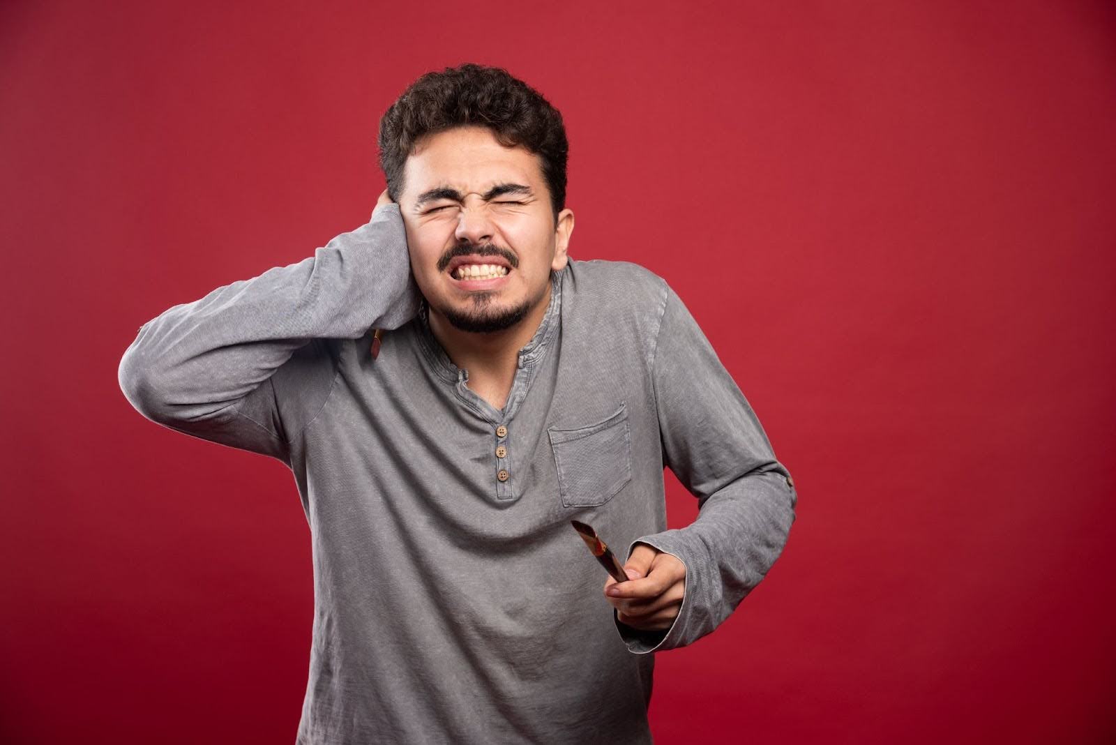 Man feeling extreme ear pain