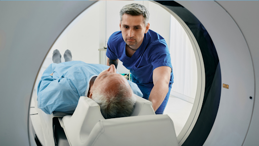 Medical technician pushing man into MRI test