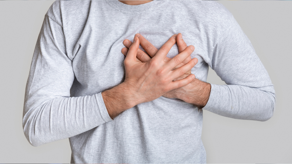 Man holding left side of his chest