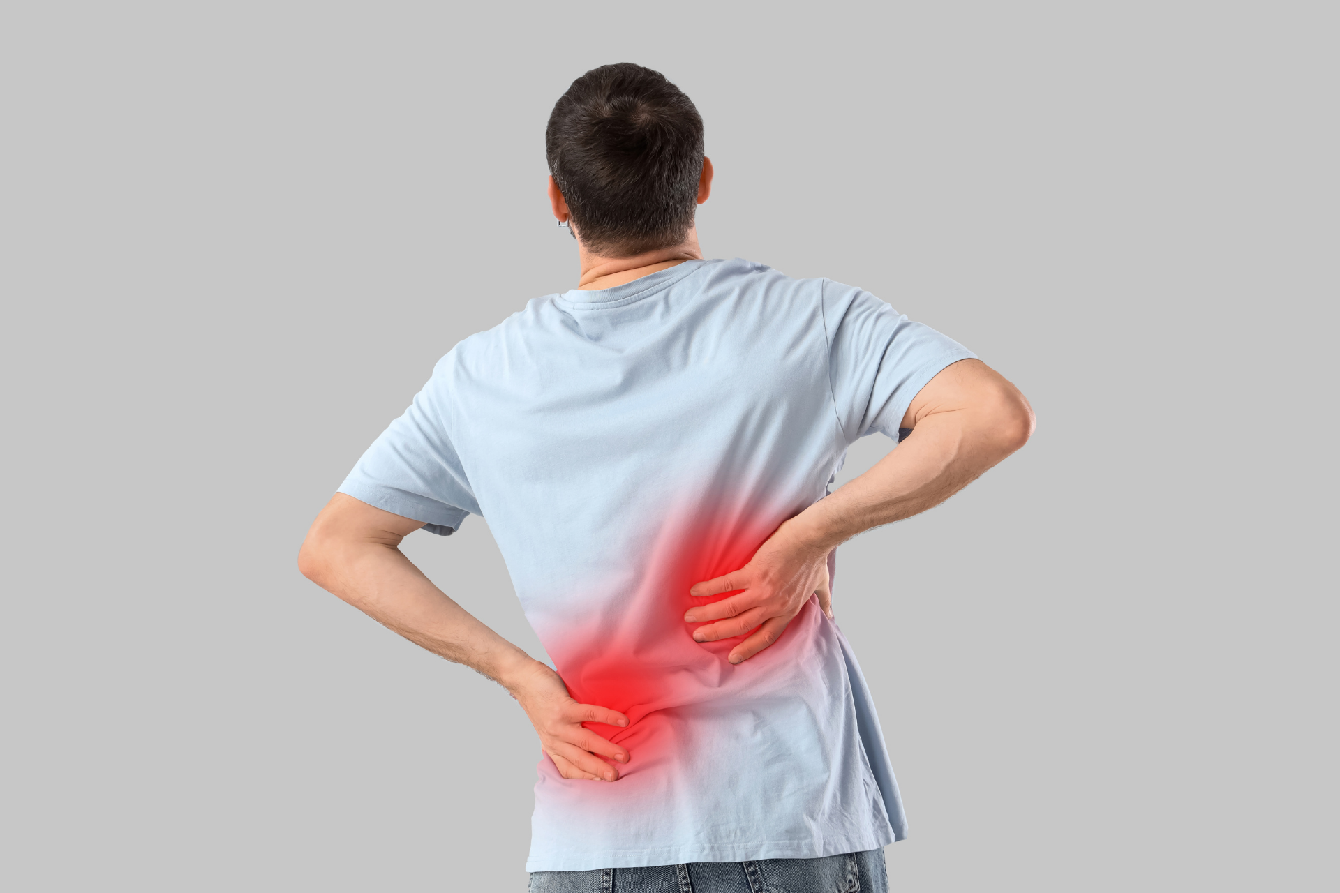 Man holding his lower back with highlighted pain area, indicating back pain or spinal discomfort