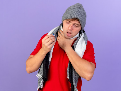 Man holding a capsule suffering from strep throat