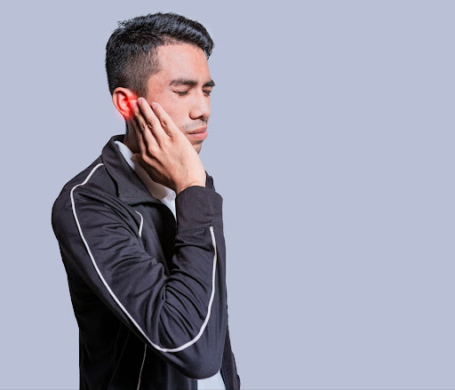 Man with hand on ear