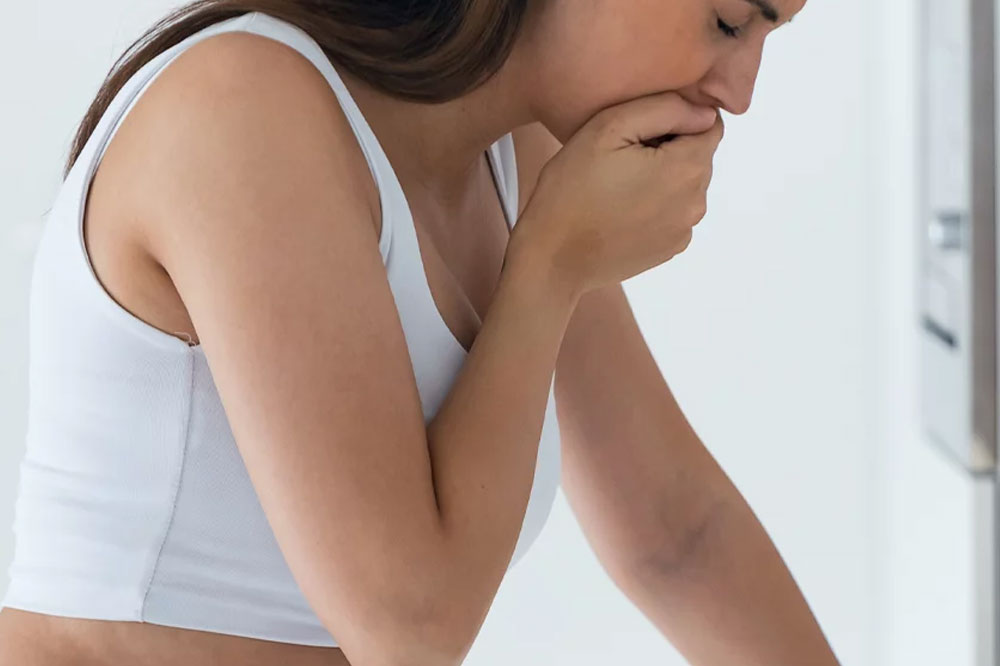 image of a woman feeling nauseous