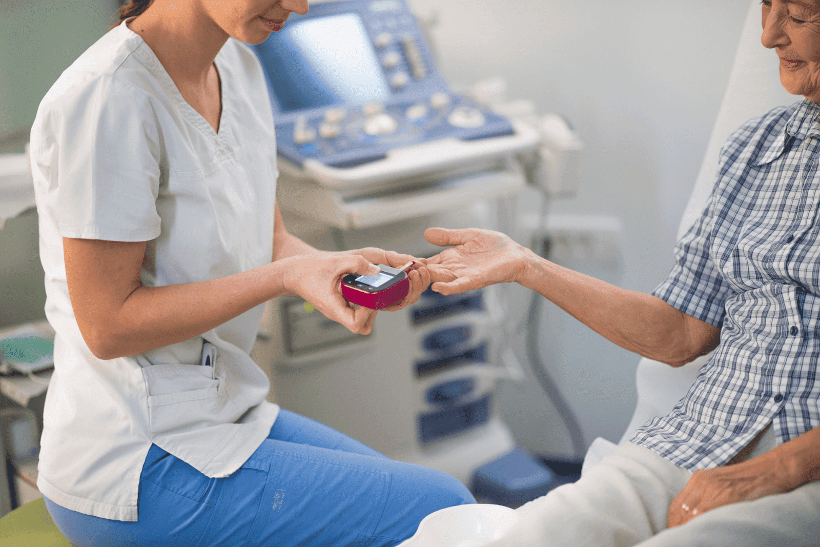 Nurse checking a patient's blood sugar level with a glucose meter