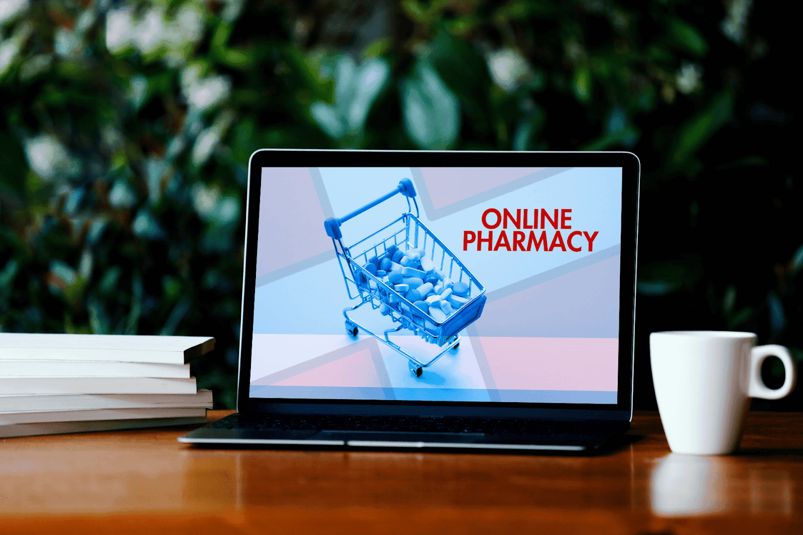 Laptop screen showing a shopping cart full of pills with the text “ONLINE PHARMACY.”